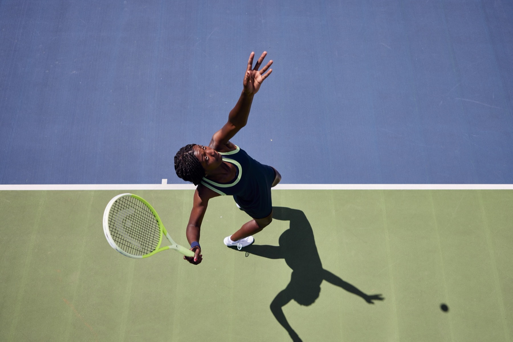 Tennisspielerin beim Aufschlag, von oben fotografiert